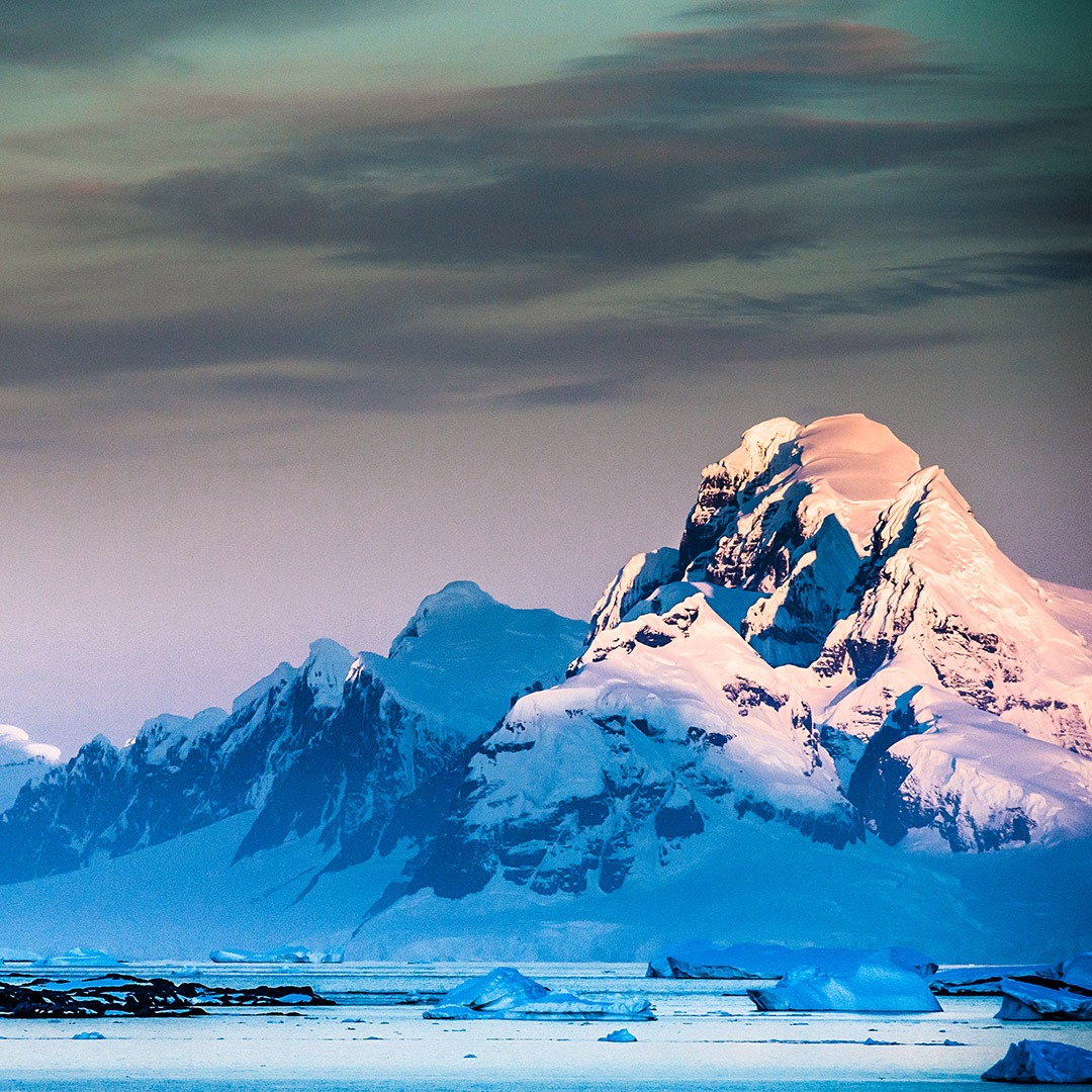 Full moon over snowy Antarctica peaks