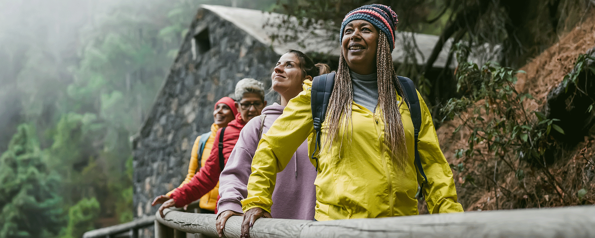 Group of people hiking in nature during a luxury group travel experience, enjoying scenic views and fresh air.